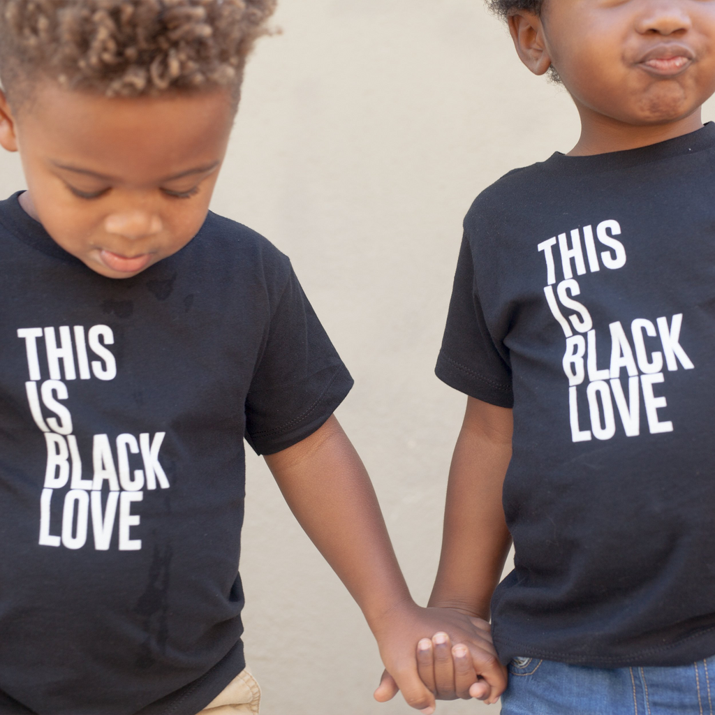 Two children wearing "This Is Black Love" short sleeve onesie. 100% Cotton unisex design for toddlers.